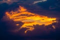 Fiery window in the clouds at sunset