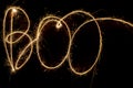 Fiery word Boo from bengal lights at night. Inscription sparklers Boo on dark background. Happy Halloween concept Royalty Free Stock Photo