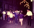 FIESTA REVELERS SINGING AND DANCING IN ONE OF THE STREETS OF JACA, SPAIN IN 1965