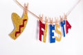 Fiesta word and sombrero made of shiny paper on pins. Fragment of festive DIY Garland of interior. Cinco de mayo celebration