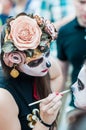 The 2018 FIFA World Cup. A National house for Mexican fans in Gostiny Dvor. Celebration of the Day of the Dead. Girl artist in flo Royalty Free Stock Photo