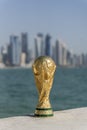 FIFA World Cup Trophy with Doha Corniche, Qatar as the background. Royalty Free Stock Photo