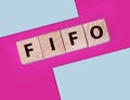 FIFO First in, first out word on wooden cubes on blue. Accounting Concept Royalty Free Stock Photo