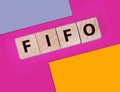 FIFO First in, first out word on wooden cubes on blue. Accounting Concept Royalty Free Stock Photo