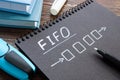 FIFO or first in first out concept. Notepad with a drawn diagram on the table. Royalty Free Stock Photo