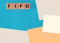 FIFO First in, first out word on wooden cubes on blue. Accounting Concept Royalty Free Stock Photo