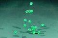 Fifteen green dices falling on a green table Royalty Free Stock Photo