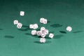 Fifteen white dices falling on a green table Royalty Free Stock Photo