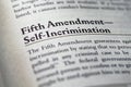 closeup of The Fifth Amendment right to not self-incrimination printed and highlighted in textbook on white page.