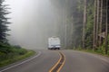 Fifth wheel travel trailer traveling on highway.