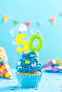 Fiftieth 50th birthday cupcake with candle blow out.Card mockup. Royalty Free Stock Photo