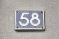 Fifty eight number in the wall of a house Royalty Free Stock Photo