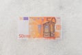 Fifty euro banknote flat lay on white snow background.Top view 50 cash