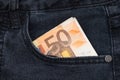 Fifty euro banknote money in pocket jeans pants background texture. 50 euro close up Royalty Free Stock Photo