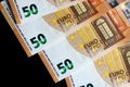 Fifty euro banknotes on a dark background