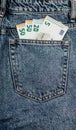 fifty euro bills in the back pocket of denim pants. concept