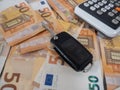 fifty euro bills on a table next to a calculator and car keys Royalty Free Stock Photo