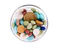 Fifty euro cents in saucer full of pills Royalty Free Stock Photo