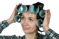 Fifty-year-old woman holding hair curlers Royalty Free Stock Photo