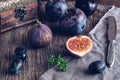 The fig is cut on a wooden table with grapes and plums. Still life with figs. Selective focus Royalty Free Stock Photo