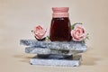 Fig jam in a glass jar on marble podium or stone beauty with rose flowers. Product promotion showcase