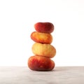 Fig peaches stack. Flat donut peaches balanced on the table Royalty Free Stock Photo