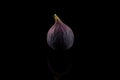 Fig, purple fig on black background, reflections, centered