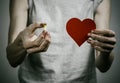 He fight against drugs and drug addiction topic: addict holding a narcotic pills on a dark background Royalty Free Stock Photo