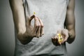 The fight against drugs and drug addiction topic: addict holding a narcotic pills on a dark background Royalty Free Stock Photo