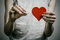 The fight against drugs and drug addiction topic: addict holding a narcotic pills on a dark background