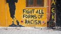 fight all forms of  racism messsage handwritten on a wall Royalty Free Stock Photo