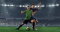 Fight for the ball. Two male soccer, football players dribbling ball at the stadium during sport match at crowded Royalty Free Stock Photo