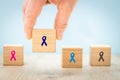 Fight cancer, Colorful ribbons on wooden cubes background, Symbol of fight against disease, cure cancer, cancer awareness day, Royalty Free Stock Photo