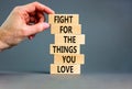 Fight for love symbol. Concept words Fight for the things you love on wooden blocks on a beautiful grey table grey background.
