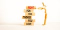 Fight for love symbol. Concept words Fight for the things you love on wooden blocks on a beautiful white table white background. Royalty Free Stock Photo