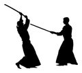 Fight between two aikido fighters silhouette.