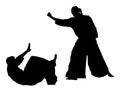 Fight between two aikido fighters silhouette. Royalty Free Stock Photo