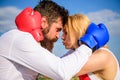 Fight for your happiness. Man and girl cuddle happy after fight. Couple in love boxing gloves hug sky background Royalty Free Stock Photo