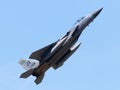 Fighter jet soaring through a bright blue sky.