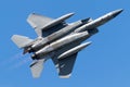 Fighter jet soaring through a bright blue sky.