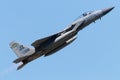 Fighter jet soaring through a bright blue sky.