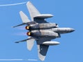 Fighter jet soaring through a bright blue sky.