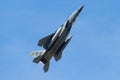 Fighter jet soaring through a bright blue sky.