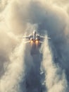 Fighter jet soaring through dense clouds with afterburners blazing, leaving a dramatic trail of vapor trailing behind in dynamic Royalty Free Stock Photo
