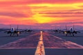 Fighter jets aligned at runway during sunset Royalty Free Stock Photo