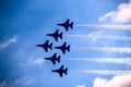 Fighter jets in formation flying past clouds