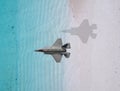 Fighter plane flies over a sea Royalty Free Stock Photo