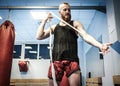 Fighter preparing for training, wrapping hands with boxing wraps