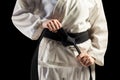 Fighter tightening karate belt