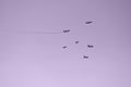 Fighters flying formation purple background